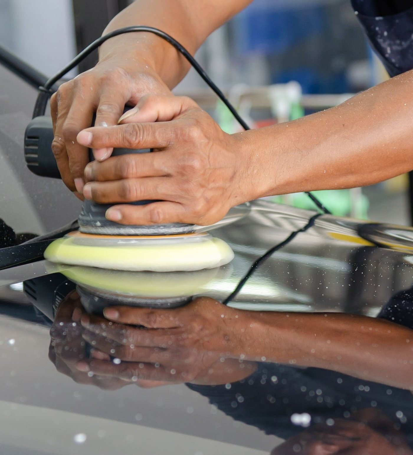 Polishing pad buffing swirl marks out of a glossy car panel